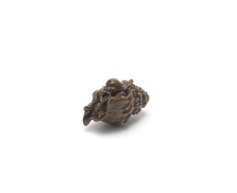 A WOOD NETSUKE OF BENKEI IN A CONCH SHELLEdo period (1615-1868), 19th centuryBenkei wearing the garb of a Yamabushi warrior-p