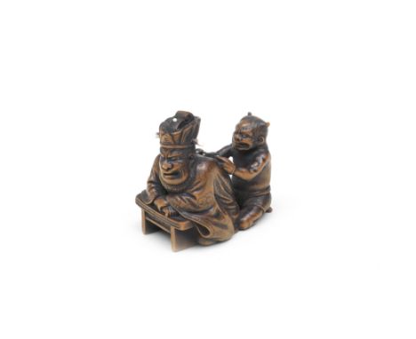 A WOOD NETSUKE OF ENMA-O AND AN ONI (DEMON)By Rakumin, Edo period (1615-1868), 19th centuryThe King of Hell seated, leaning a