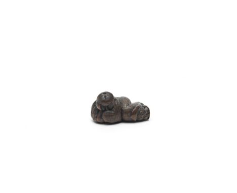 A WOOD NETSUKE OF A SLEEPING SHOJO (DRUNKEN SPRITE)By Tamekazu, Edo period (1615-1868) or Meiji era (1868-1912), 19th century