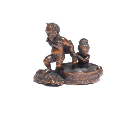 A WOOD NETSUKE OF RAIJIN WITH A BATHING WOMANBy Suketada, Takayama, Hida Province, Edo period (1615-1868), probably mid 19th 