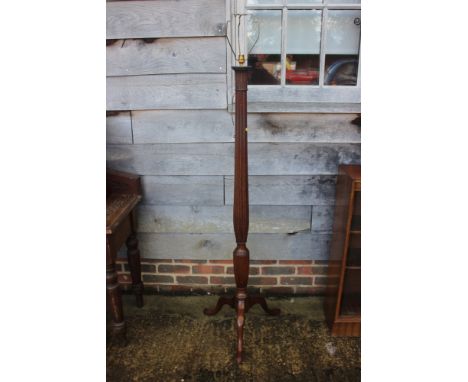 An early 20th century turned and fluted mahogany standard lamp 