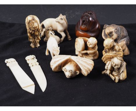 Eight Japanese ivory netsukes, a wooden netsuke, an ivory book marker, a similar letter opener and a carved ivory model of a 