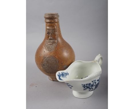 A 17th century stoneware "Bellarmine", 8 1/2" high (no handle) and an early Worcester sauce boat, 7" long 