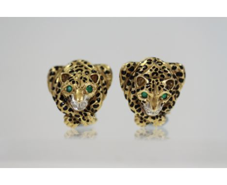 A pair of yellow metal earrings, formed as crouching leopards, set emeralds, diamonds and black enamel 