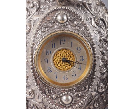 An embossed easel clock with bird and scroll decoration, 7 1/4" high 