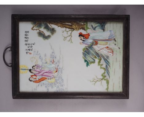 A Chinese ceramic panel with polychrome decoration of figures in a landscape, in hardwood frame, 16" high x 11 1/2" wide over