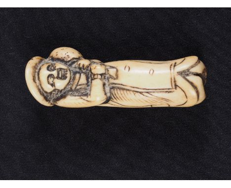 A Japanese carved antler netsuke, formed as a Dutchman holding a ham hock, 2 1/4" longCondition:Light rubbing around the deta