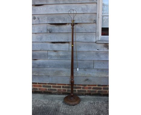 A mahogany standard lamp, on turned column and circular base, 60 1/2" high 
