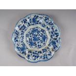 An 18th century majolica lobed dish with floral decoration, 10 1/4" dia (restored)