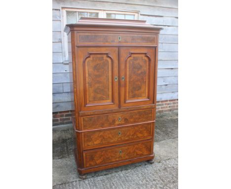 A Continental figured walnut and banded cocktail cabinet, fitted one drawer over cupboard enclosing drawers and shelves, over