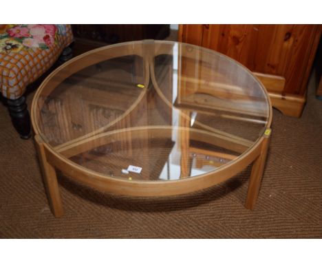 A light oak circular glass topped coffee table, on tripod supports, 32 1/2" dia x 13 1/2" high 