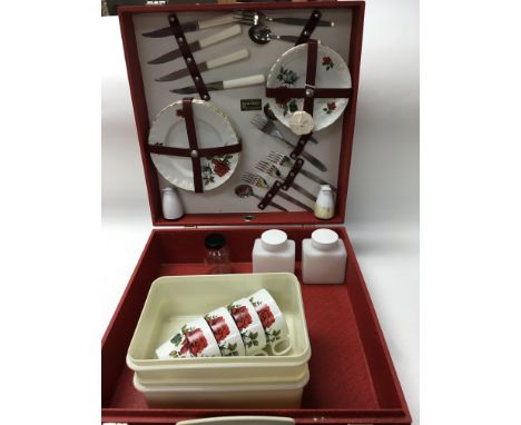 A Brexton vintage picnic set. Complete with 4 knives, 5 forks, 3 teaspoons. Salt and pepper dispensers (one damaged). 4 rose 
