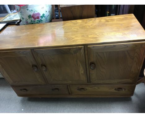 A Ercol sideboard fitted with three cupboard doors with two drawers.130 cm by 40 cm .