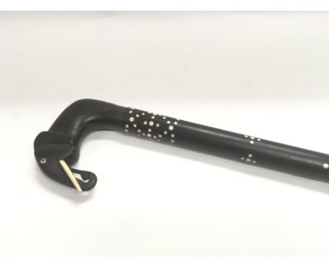 An ebonised walking stick elephant head handle.