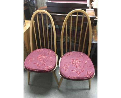 A set of four Ercol stick back dining chairs