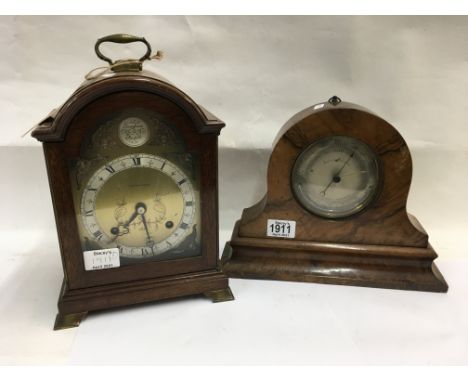 A Burrwalnut cased aneroid barometer together with a Cased Mantle clock by Alexander Clarke.