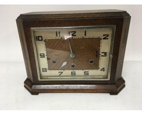 An Art Deco design oak mantel clock.