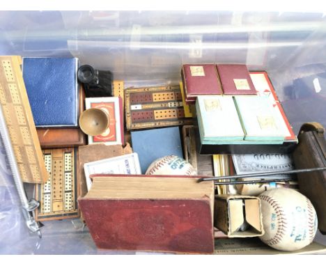 A box containing a collection of vintage games including Monopoly, playing cards, a softball mitt, chess and others - NO RESE