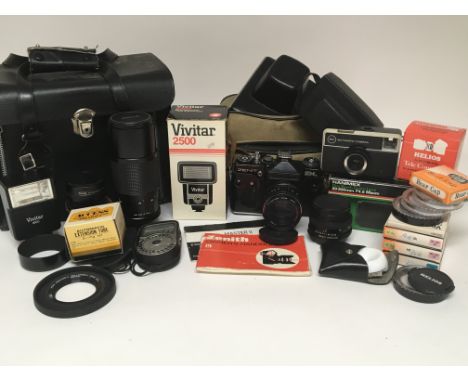 A collection of cameras, lenses and other photographic accessories including a Zenit EM and a Kodak Instamatic