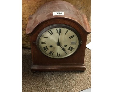 An Edwardian mantel clock the silvered dial with Roman numerals seen working with key.