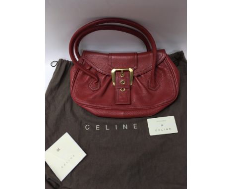 A red leather Celine hand bag, complete with original dust cover. The inside has a small zip pocket and black fabric lining. 