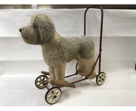 A vintage tri-ang push along dog.