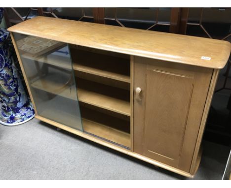 A modern design light oak display or bookcase cabinet with glass sliding doors flanked by a single cupboard - NO RESERVE