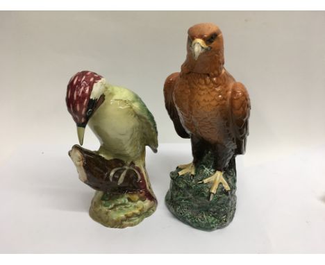 A Beswick wood pecker and a Beswick golden eagle decanter.