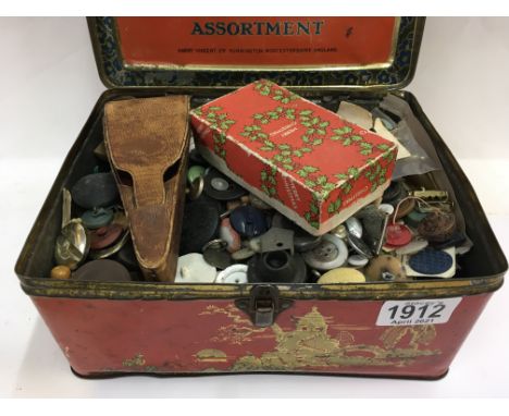 A tin with a huge assortment of Vintage buttons and a case of sewing scissors.