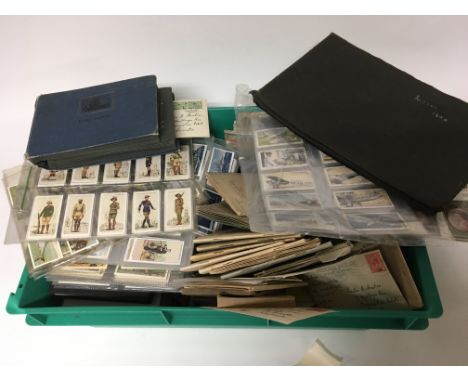 A collection of cigarette cards in presentation sleeves and books and a quantity of vintage postcards. (a lot)