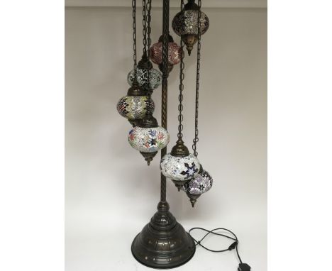 A standard lamp in the Moorish style with 7 graduated shades, with multicolour inset, supported by a spiral stem. Height 148c