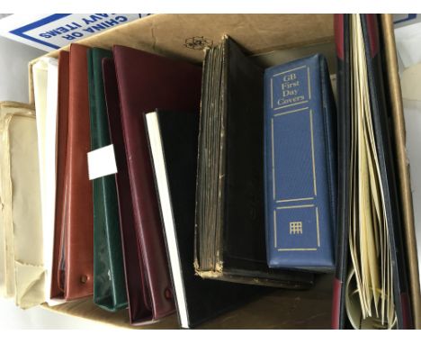 Two boxes containing albums of first day covers an album of cigarette cards Bentley car cards and other oddments (a lot)