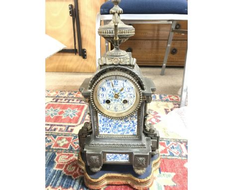 A Victorian mantel clock with floral panels.