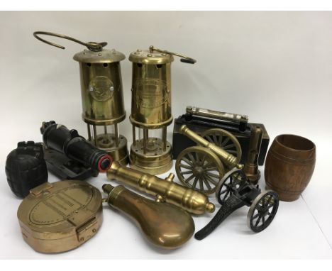 Two Miners lamps, together with miniature model cannons, a powder flask, reproduction Stanley compass etc