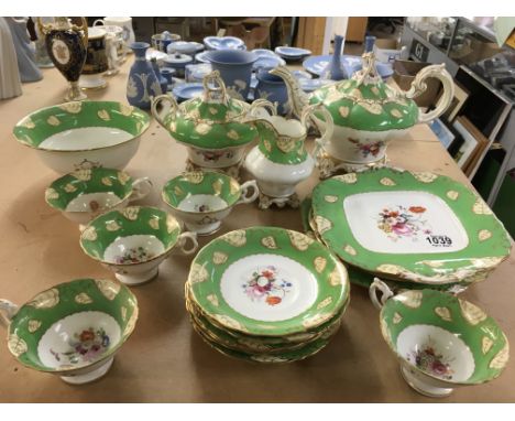 A 19th century part tea service in the Rockingham style decorated with flowers and foliage -with an applied Godden Reference 