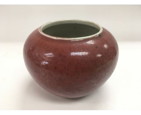 A red ceramic brush washing vase, approx height 10cm.