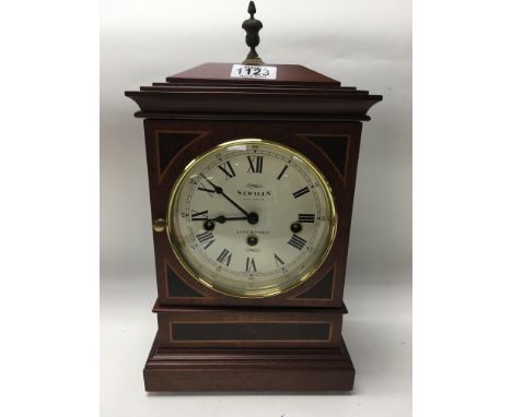 A modern chiming mantle clock of Georgian style. The circular dial with Roman numerals by Sewills of Liverpool. Height 37cm a