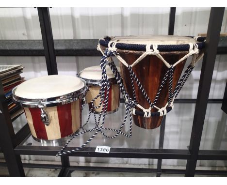 Pair of modern wood and stainless steel bongo drums and an Ethnic type drum 