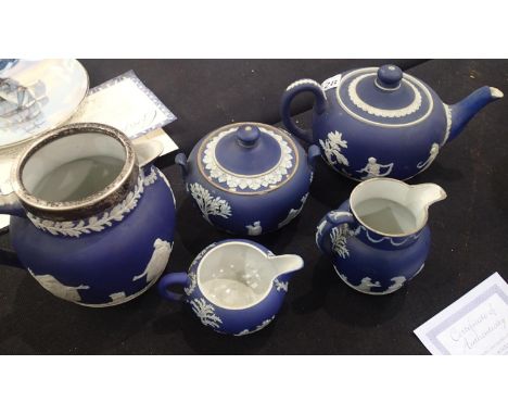 Wedgwood five piece blue jasperware tea set to include a milk jug, cream jug, sugar bowl etc 