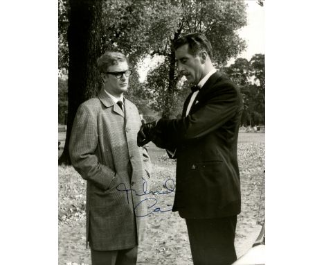 CAINE MICHAEL: (1933-     ) English actor, Academy Award winner. Vintage signed 7.5 x 9.5 photograph of Caine standing outdoo
