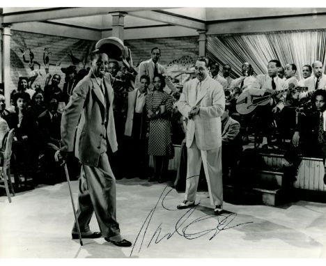 ELLINGTON DUKE: (1899-1974) American jazz composer and pianist. Vintage signed 9.5 x 7 photograph of Ellington standing in a 