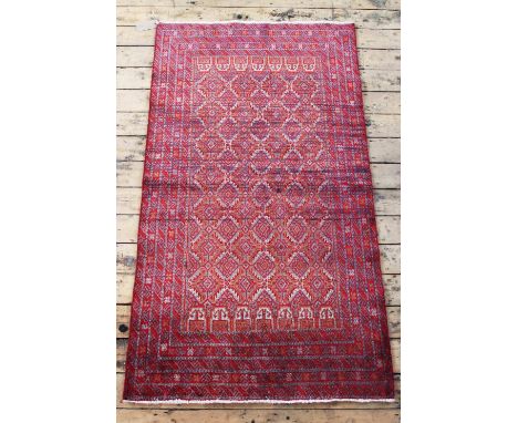 An Iranian wool rug, worked with a panel of gulls against a red ground, 162cm x 85cm