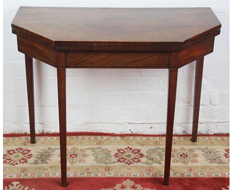 A George III mahogany card table, with canted corners, on tapered square legs. 74cm x 92cm x 45cm