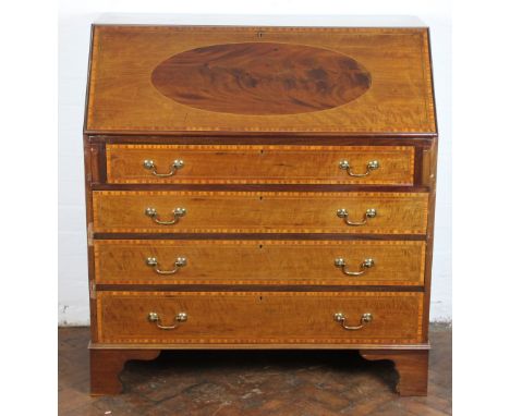 An Edwardian inlaid mahogany bureau, with fall enclosing a fitted interior, over four graduated long drawers, on bracket feet
