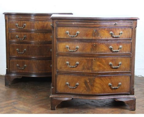 A pair of reproduction mahogany serpentine chests, with brush slide above four graduated long drawers and fluted corner angle