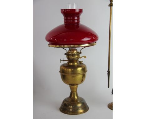 A Victorian brass oil lamp, with opaque red glass shade; a brass coal scuttle; another coal scuttle; and other metalwares