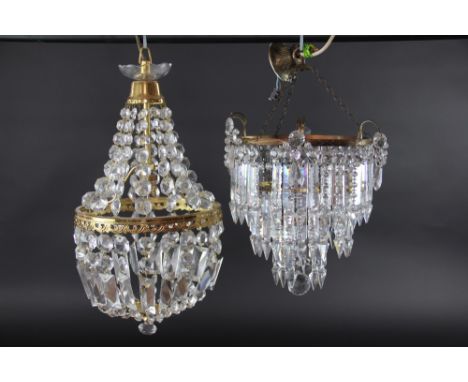 A cut glass drop three tier light fitting, suspending graduated faceted glass drops, 29 cm wide, and another gilt metal and g