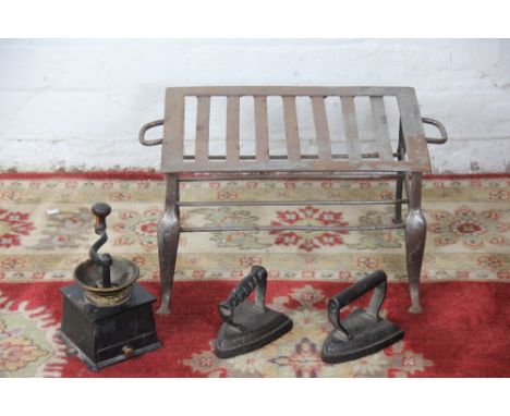 An early 19th century steel footman, 43cm; a cast iron coffee grinder; two iron irons (4)
