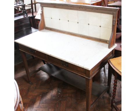 An Edwardian oak wash stand, with tile back and veined white marble top, above two drawers with Art Nouveau copper handles, o