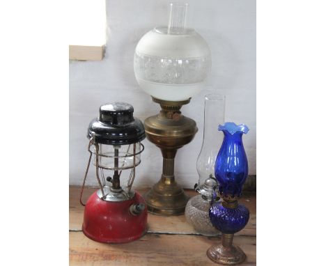 A brass oil lamp with frosted shade; a tilly lamp with red enamel base, three brass taps and two further lamps (7)